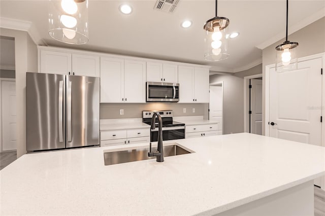 16280 Minorca Dr, Punta Gorda, FL 33955 - kitchen with stainless steel appliances, a sink, ornamental molding, white cabinetry, and decorative light fixtures