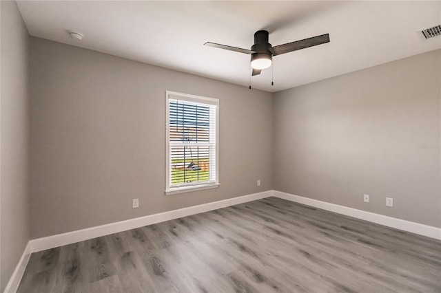 16280 Minorca Dr, Punta Gorda, FL 33955 - spare room featuring wood finished floors, ceiling fan, baseboards, and a smoke detector