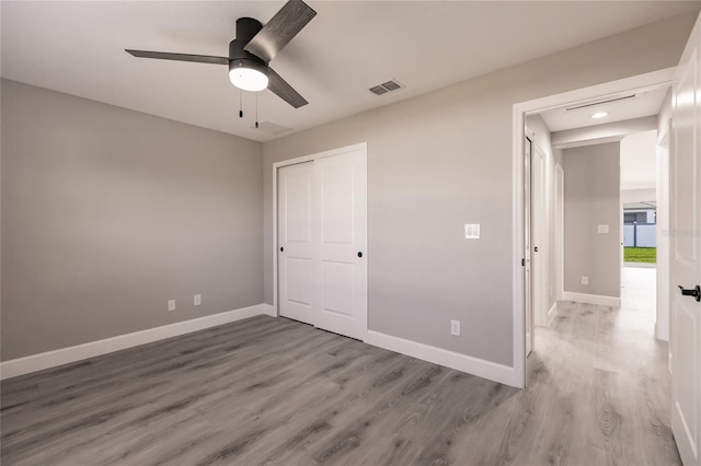 16280 Minorca Dr, Punta Gorda, FL 33955 - unfurnished bedroom featuring wood finished floors, baseboards, a closet, recessed lighting, and a ceiling fan