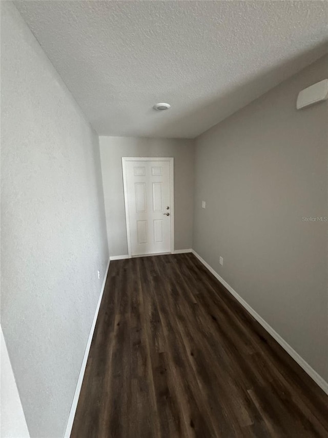 16280 Minorca Dr, Punta Gorda, FL 33955 - unfurnished bedroom with dark wood-type flooring and a textured ceiling