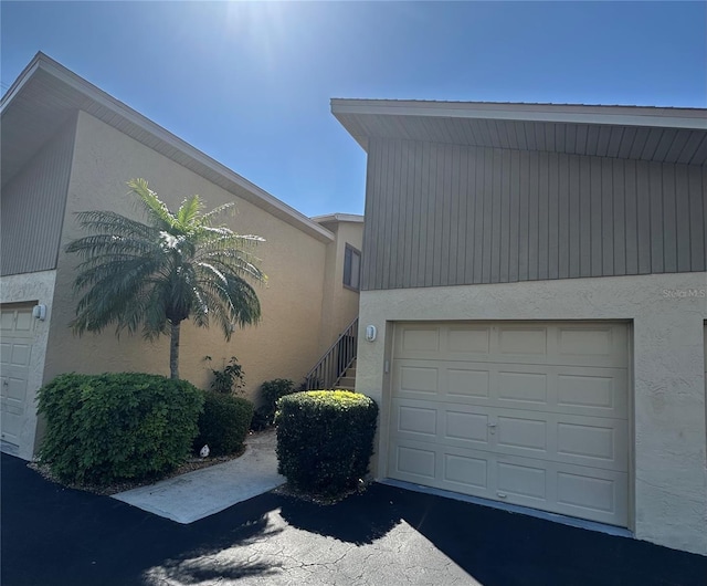 4120 SE 19th Pl Unit 202, Cape Coral, FL 33904 - view of side of property with stucco siding and a garage