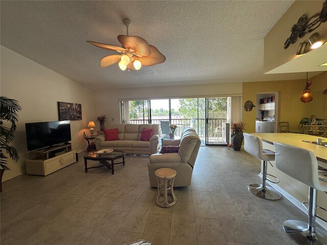 4120 SE 19th Pl Unit 202, Cape Coral, FL 33904 - living room with a textured ceiling, a ceiling fan, and washer / clothes dryer