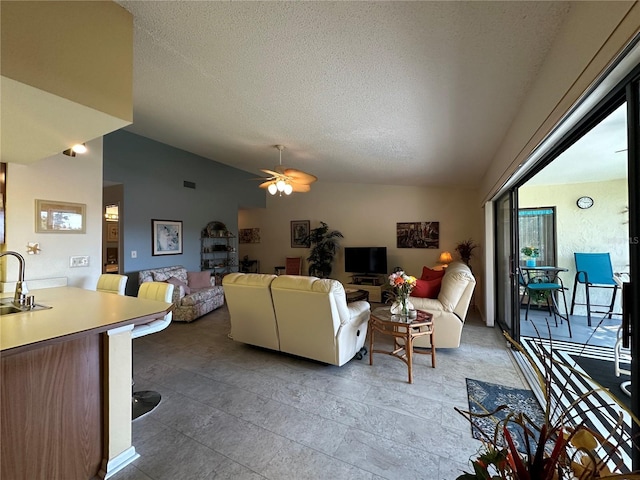 4120 SE 19th Pl Unit 202, Cape Coral, FL 33904 - living area featuring vaulted ceiling, ceiling fan, and a textured ceiling
