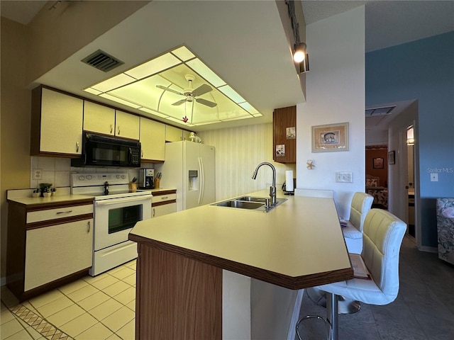 4120 SE 19th Pl Unit 202, Cape Coral, FL 33904 - kitchen featuring white appliances, a sink, light tile patterned floors, a peninsula, and light countertops