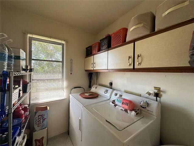 4120 SE 19th Pl Unit 202, Cape Coral, FL 33904 - washroom with cabinet space, washing machine and dryer, baseboards, and light tile patterned flooring