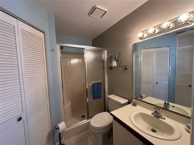 4120 SE 19th Pl Unit 202, Cape Coral, FL 33904 - bathroom featuring a closet, toilet, a stall shower, tile patterned flooring, and vanity