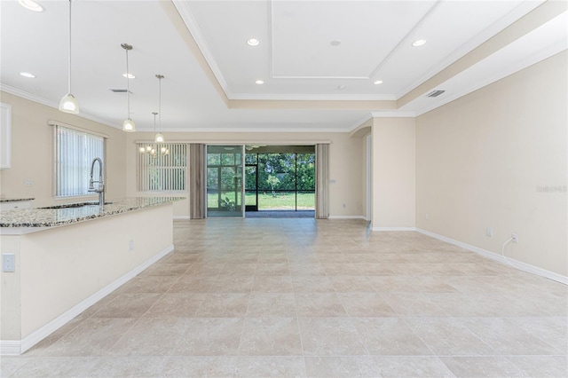 11666 Parrotfish St, Venice, FL 34292 - unfurnished living room featuring a sink, a raised ceiling, ornamental molding, baseboards, and recessed lighting