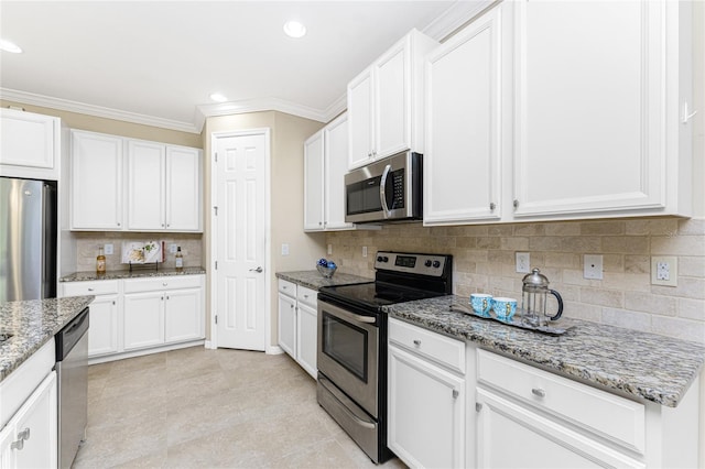 11666 Parrotfish St, Venice, FL 34292 - kitchen with appliances with stainless steel finishes, ornamental molding, white cabinetry, light stone counters, and decorative backsplash