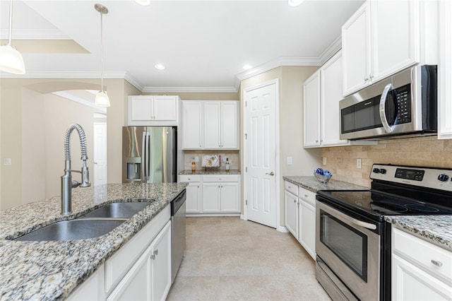 11666 Parrotfish St, Venice, FL 34292 - kitchen with appliances with stainless steel finishes, a sink, white cabinetry, backsplash, and ornamental molding