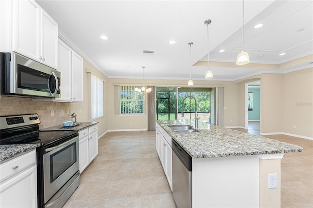 11666 Parrotfish St, Venice, FL 34292 - kitchen with stainless steel appliances, a sink, ornamental molding, tasteful backsplash, and baseboards