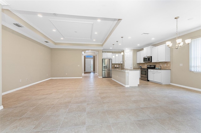 11666 Parrotfish St, Venice, FL 34292 - kitchen with stainless steel appliances, open floor plan, a sink, a tray ceiling, and a chandelier