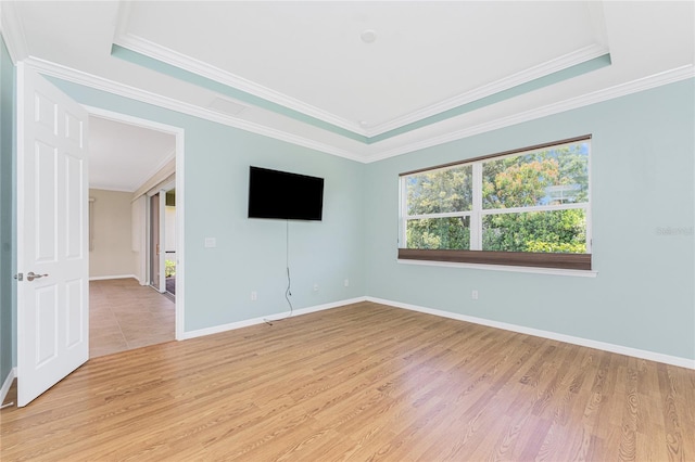 11666 Parrotfish St, Venice, FL 34292 - spare room with light wood-style flooring, ornamental molding, baseboards, and a tray ceiling