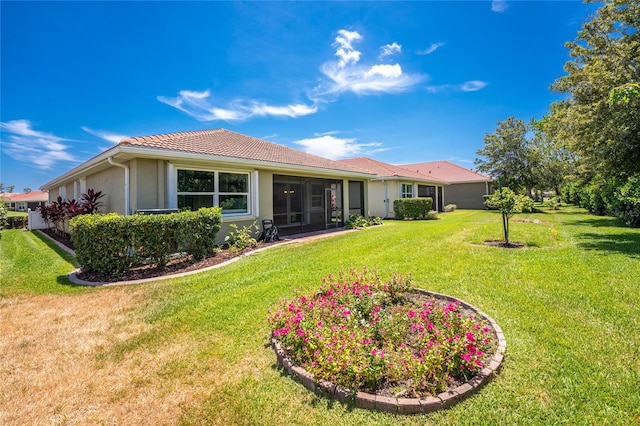11666 Parrotfish St, Venice, FL 34292 - back of property featuring stucco siding, a yard, and a tile roof