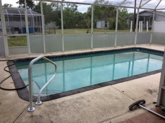 23220 Rountree Ave, Port Charlotte, FL 33980 - outdoor pool with a shed, glass enclosure, and a patio