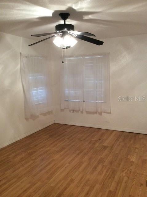 23220 Rountree Ave, Port Charlotte, FL 33980 - unfurnished room featuring wood finished floors and a ceiling fan