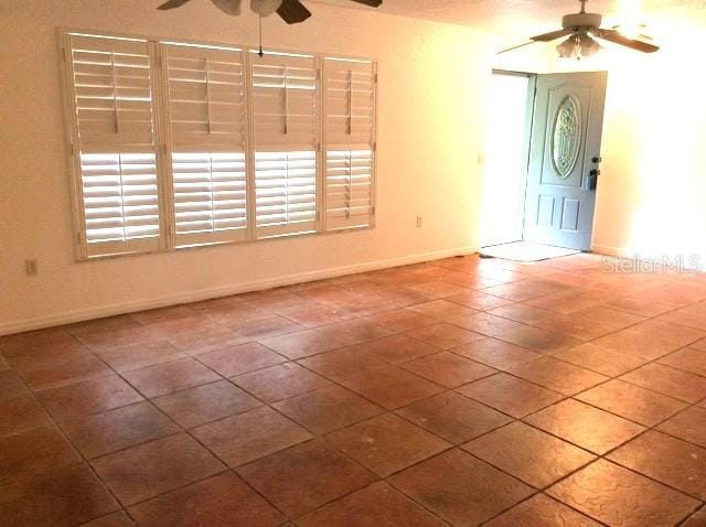23220 Rountree Ave, Port Charlotte, FL 33980 - empty room with a ceiling fan and tile patterned flooring