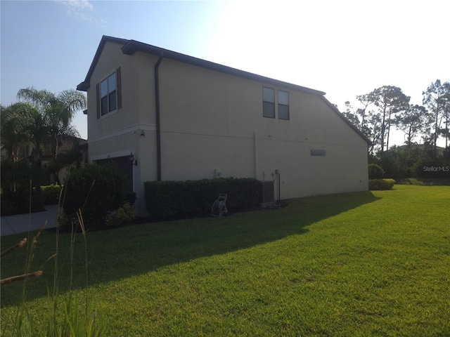 2739 Sherman Oak Dr, North Port, FL 34289 - view of side of home featuring a lawn and stucco siding