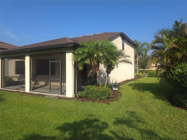 2739 Sherman Oak Dr, North Port, FL 34289 - rear view of property with a lawn and stucco siding