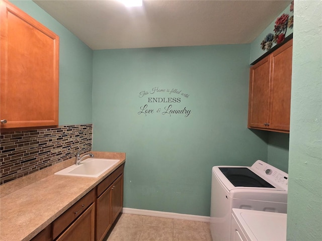 2739 Sherman Oak Dr, North Port, FL 34289 - laundry room featuring washing machine and clothes dryer, cabinet space, light tile patterned floors, and baseboards