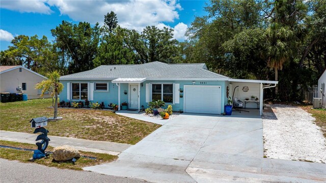 7231 Elyton Dr, North Port, FL 34287 - single story home featuring a front yard, concrete driveway, a garage, a carport, and a shingled roof