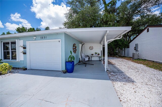 7231 Elyton Dr, North Port, FL 34287 - garage with concrete driveway and central AC unit