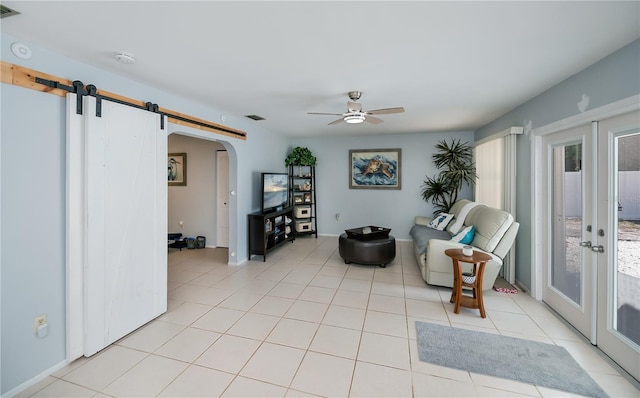 7231 Elyton Dr, North Port, FL 34287 - sitting room with arched walkways, a ceiling fan, light tile patterned floors, french doors, and baseboards