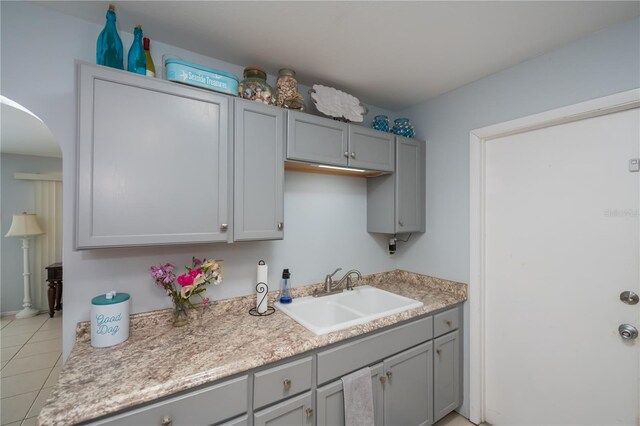 7231 Elyton Dr, North Port, FL 34287 - laundry room featuring a sink, arched walkways, and light tile patterned floors