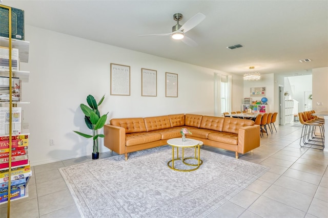 111 Rain Lily Ave, Spring Hill, FL 34609 - living room featuring light tile patterned floors, a ceiling fan, and a chandelier