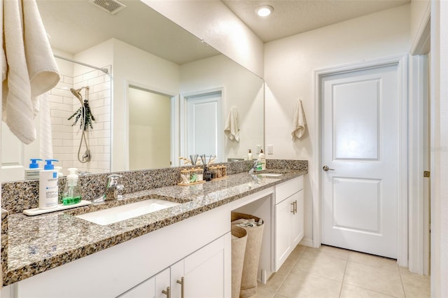 111 Rain Lily Ave, Spring Hill, FL 34609 - bathroom featuring double vanity, tile patterned floors, and tiled shower