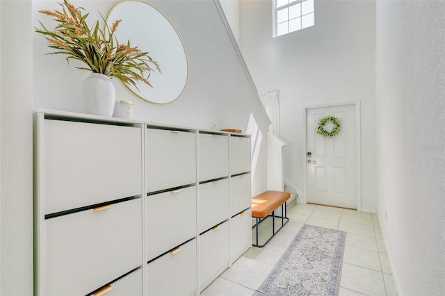 111 Rain Lily Ave, Spring Hill, FL 34609 - foyer with light tile patterned floors, a high ceiling, and stairway