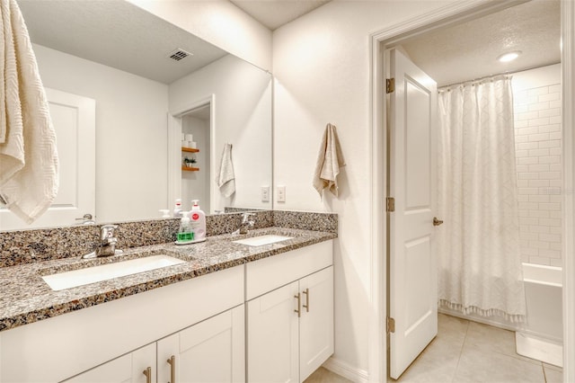 111 Rain Lily Ave, Spring Hill, FL 34609 - bathroom featuring double vanity, tile patterned flooring, shower / bath combo with shower curtain, and a textured ceiling