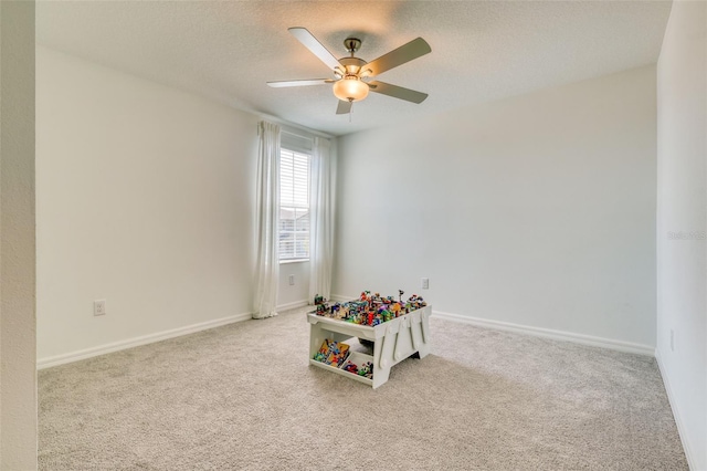 111 Rain Lily Ave, Spring Hill, FL 34609 - playroom with ceiling fan, carpet floors, and a textured ceiling