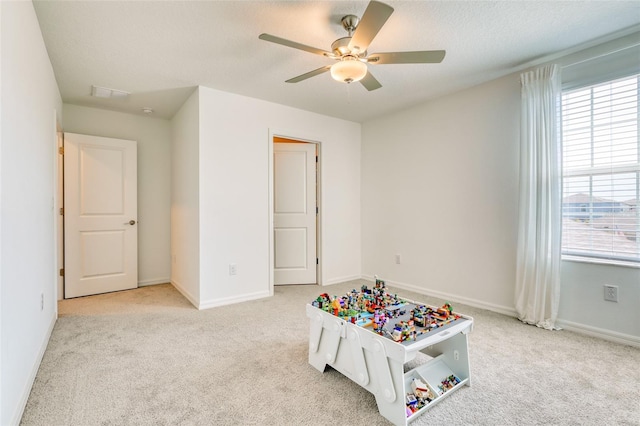 111 Rain Lily Ave, Spring Hill, FL 34609 - game room with light colored carpet and ceiling fan