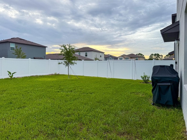 111 Rain Lily Ave, Spring Hill, FL 34609 - yard at dusk featuring a fenced backyard