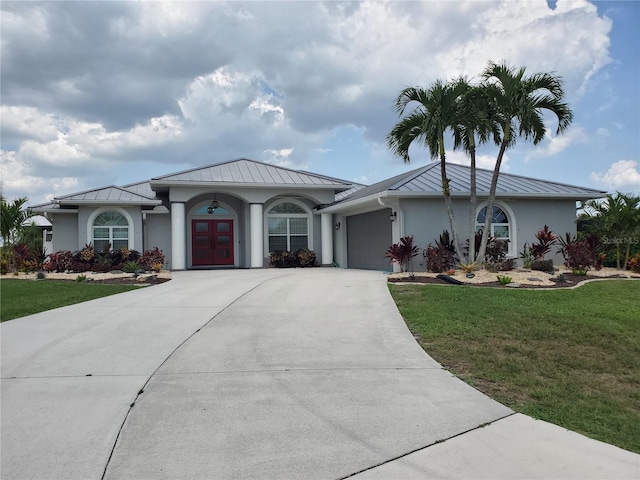 4216 Bur St, Port Charlotte, FL 33948 - ranch-style house with a standing seam roof, stucco siding, french doors, metal roof, and a front lawn