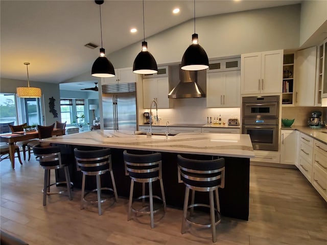 4216 Bur St, Port Charlotte, FL 33948 - kitchen with stainless steel appliances, wall chimney range hood, lofted ceiling, light stone countertops, and backsplash