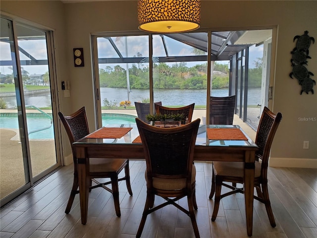 4216 Bur St, Port Charlotte, FL 33948 - dining area with a water view, wood finished floors, and baseboards