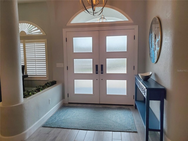 4216 Bur St, Port Charlotte, FL 33948 - foyer entrance with french doors, light wood-style flooring, a chandelier, and baseboards