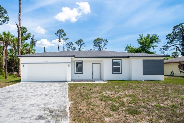 17197 Russell Ave, Port Charlotte, FL 33954 - single story home featuring an attached garage, decorative driveway, stucco siding, and a front yard