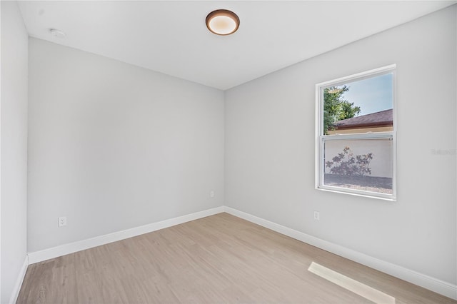 17197 Russell Ave, Port Charlotte, FL 33954 - empty room featuring wood finished floors, baseboards, and a smoke detector