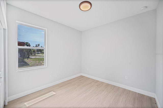 17197 Russell Ave, Port Charlotte, FL 33954 - empty room with wood finished floors, baseboards, and a smoke detector
