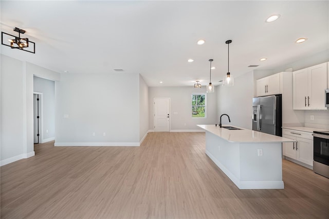 17197 Russell Ave, Port Charlotte, FL 33954 - kitchen with stainless steel appliances, a sink, light countertops, light wood-style floors, and white cabinets