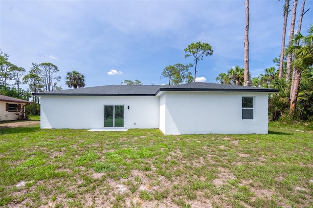 17197 Russell Ave, Port Charlotte, FL 33954 - rear view of property with stucco siding and a lawn