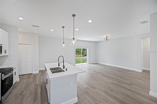 16218 Chamberlain Blvd, Port Charlotte, FL 33954 - kitchen featuring appliances with stainless steel finishes, a sink, light wood finished floors, light countertops, and recessed lighting