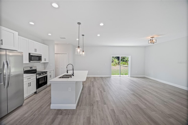 16218 Chamberlain Blvd, Port Charlotte, FL 33954 - kitchen with stainless steel appliances, a sink, open floor plan, light wood-type flooring, and recessed lighting
