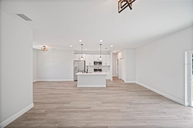 16218 Chamberlain Blvd, Port Charlotte, FL 33954 - unfurnished living room with a sink, recessed lighting, baseboards, and light wood-type flooring