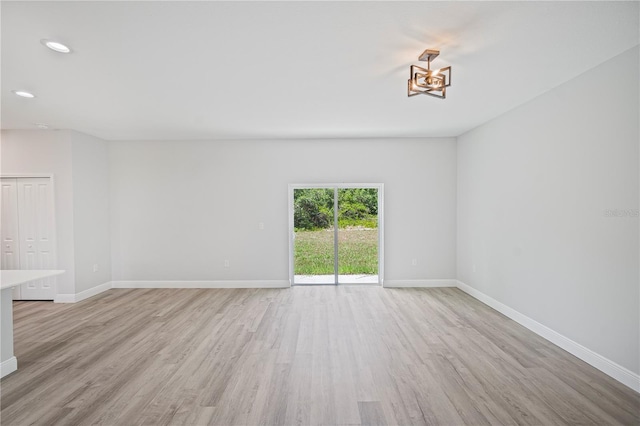 16218 Chamberlain Blvd, Port Charlotte, FL 33954 - empty room featuring light wood-style floors, baseboards, recessed lighting, and a chandelier