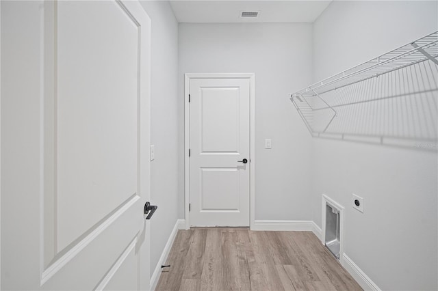 16218 Chamberlain Blvd, Port Charlotte, FL 33954 - laundry area with hookup for an electric dryer, light wood-style flooring, and baseboards
