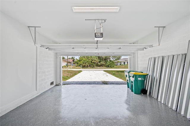 16218 Chamberlain Blvd, Port Charlotte, FL 33954 - garage featuring a garage door opener and baseboards