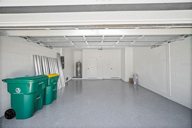 16218 Chamberlain Blvd, Port Charlotte, FL 33954 - garage with water heater, concrete block wall, and electric panel